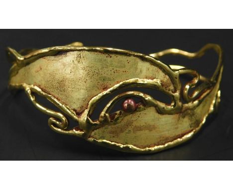A modern abstract bangle, with pierced and bi-colour decoration. 