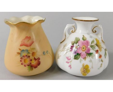 A Royal Worcester porcelain two handled vase, decorated with flowers on a white ground, printed mark in puce, and a tapering 