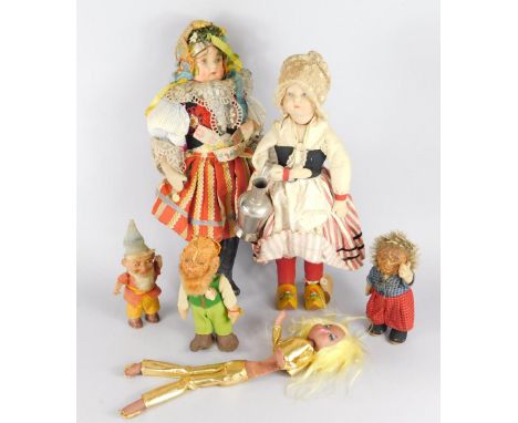A collection of early to mid 20thC costume dolls, to include a Flemish girl carrying a flagon, wearing painted wooden clogs, 