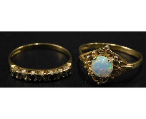 Two 9ct gold dress rings, to include a half hoop eternity ring set with blue and white stones, and an opal set dress ring, 2.