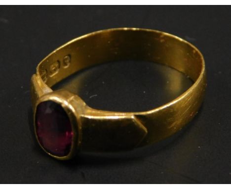 A 22ct gold dress ring, set with oval cut ruby, with arrowed shoulders, on a possibly later band, Birmingham assay, 3.1g all 