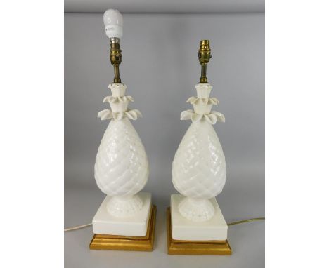 A pair of large cream glazed pottery table lamps, each modelled in the form of a pineapple on a gilt base, 63cm high to top o