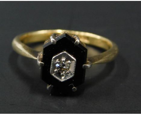 A dress ring, set with hexagonal black stone, with tiny diamond to centre, on yellow metal band, marked 18ct, 2.7g all in. 