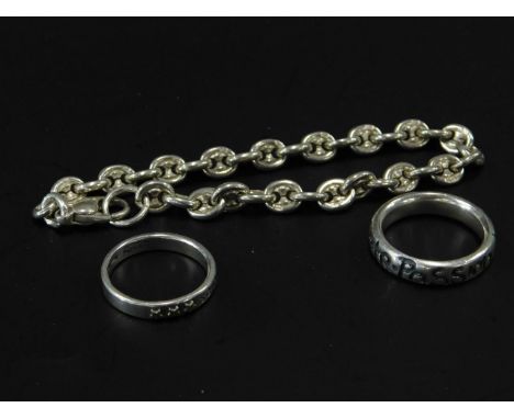 Three items of silver jewellery, to include a silver fancy link bracelet, a silver three wishes ring, and a silver chocolate,