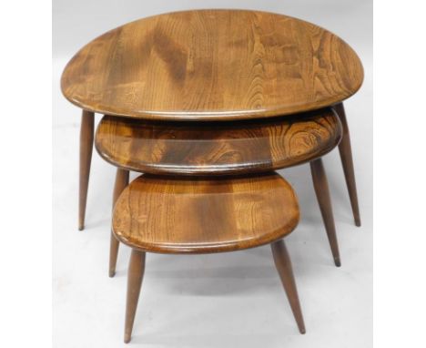 A nest of three Ercol pebble tables, on turned legs, the largest 64cm wide