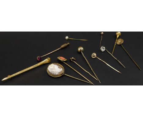 Eleven stick pins and a bar brooch, to include a gold plated bar brooch, seven gold plated stick pins, some stone set, one wi