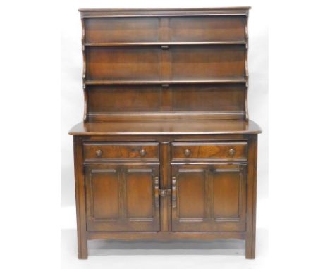 An Ercol dresser, the plate rack with two shelves, the base with two drawers above two panelled doors, on stiles, 121cm wide