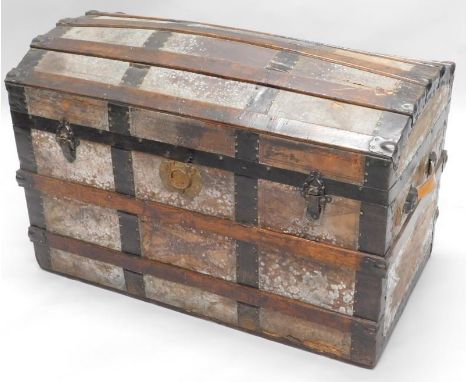 An early 20thC oak and canvas domed top trunk, 88cm wide.