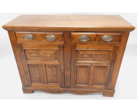 A late Victorian walnut sideboard, the top with a moulded edge, above two short drawers and two panelled doors on bracket fee