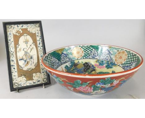 An oriental porcelain bowl, decorated to the interior with figures etc., the exterior with flowers and a small framed silk pa