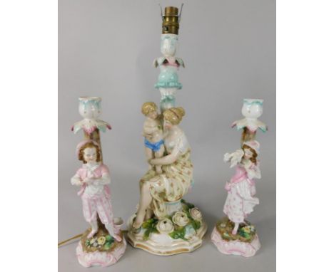 A Dresden flower encrusted porcelain lamp base, and two similar figures, 43cm high to top of light fitting