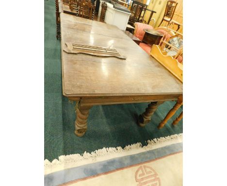 An early 20thC oak snooker dining table, the loose rectangular top with a moulded edge, the table with a slate bed on spirall