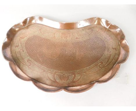 An early 20thC Art Nouveau style tray, in a manner of Newlyn decorated with scrolls and with a central stylised scale area, u