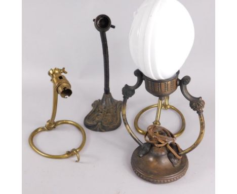 Four metal lamp bases, to include an adjustable early 20thC example with a cast iron base, a similar pressed brass metal base