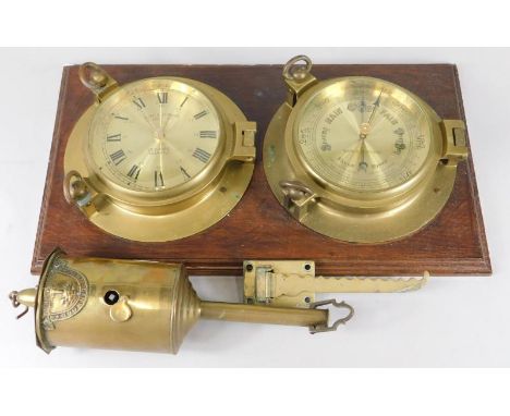 A replica ship's clock and barometer, made by Mark & Stevens Co Limited, and a brass spit jack