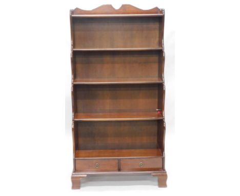 A mahogany waterfall type open bookcase, with two frieze drawers, on ogee bracket feet, 76cm wide.