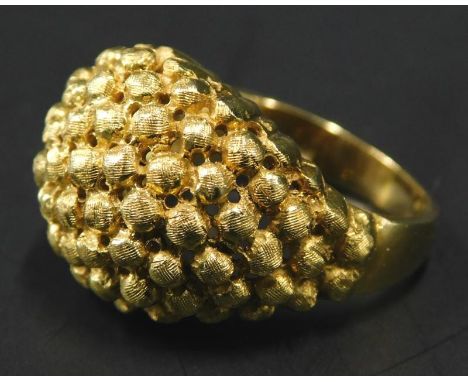 An abstract dress ring, of pierced and brushed ball design, yellow metal, marked 319AL, 9.2g all in. 