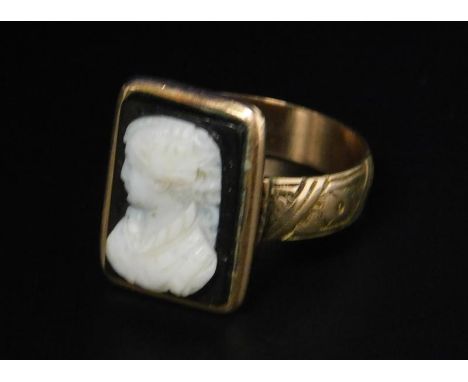 A Victorian intaglio dress ring, with a raised half portrait of a lady, on black agate back, on a 15ct gold band, with floral