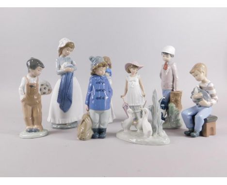 A collection of Nao porcelain, to include a duck group, boy with football, similar figure of a boy in a duffel coat, nursing 