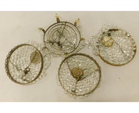 A set of three gilt metal and cut glass basket type light fittings, and another with leaf cast decoration, 25cm diameter.