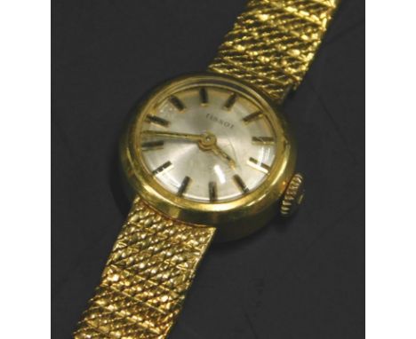 A ladies Tissot wristwatch, with small circular watch head, on a silvered dial, on solid bracelet, marked 18k, 24g all in. 