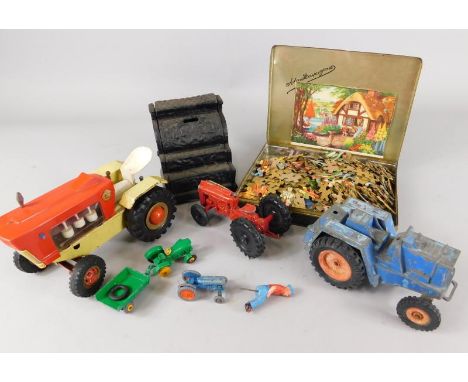 Various toys, to include a cast iron money box modelled in the form of a cash register, a clockwork tractor etc.