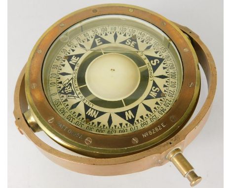 A brass and copper military issue nautical compass, patent number 0195a, on a gimble, 32cm wide