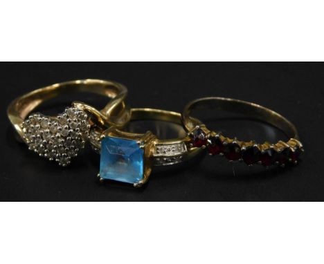 Three dress rings, to include two 9ct gold stone set dress rings, and a silver and garnet dress ring (3). 