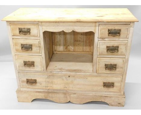 A 19thC pine side cabinet, the rectangular top with a moulded edge, above an arrangement of six short drawers, flanking a cen