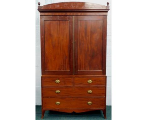 A George III mahogany press cupboard, the upper section with two doors revealing sliding shelves, the base with two short and
