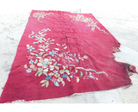 An Indian red ground carpet, with floral decoration. (AF)