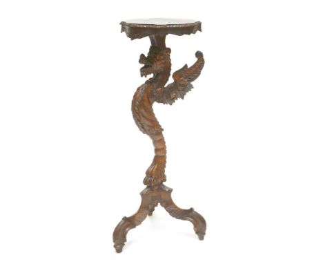 A softwood torchère,19th century, carved as a dragon standing on a tripod base,94cm high