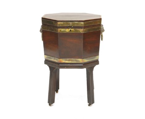 A George III mahogany octagonal brass bound wine cooler,with a crossbanded top above lion's mask ring handles, a lead-lined i