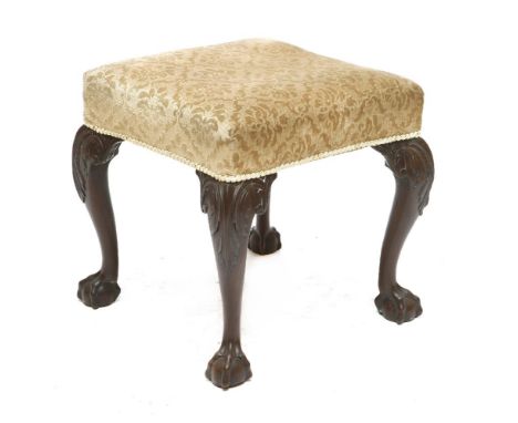 A Chippendale-style footstool,19th century, the upholstered seat on carved mahogany claw and ball feet,48cm square48cm high