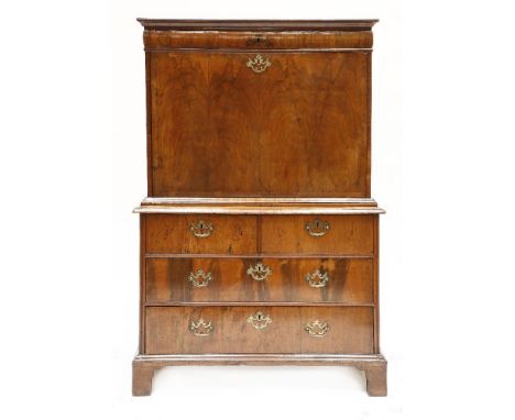 A Queen Anne walnut escritoire,the top section with a frieze drawer over a fall front and typically fitted interior, the base