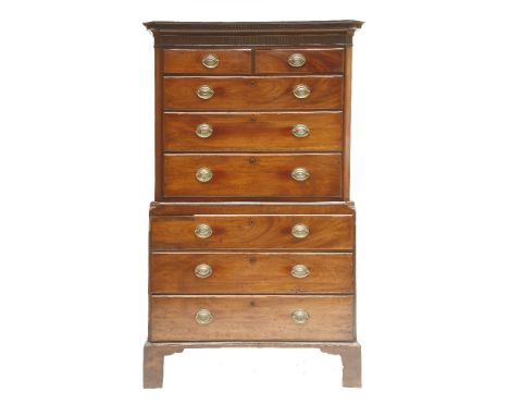 A George III mahogany chest on chest, the top section with a dentil cornice and fluted frieze, over two short and three long 