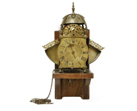 A brass winged lantern clock,late 17th century, by William Speakman, Hatton Garden, London, the bell over pierced brackets wo