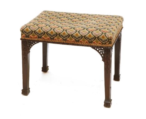 A Chippendale-style mahogany footstool,with a needlepoint seat, over carved square legs and pieced brackets,top 60 x 42cm44cm