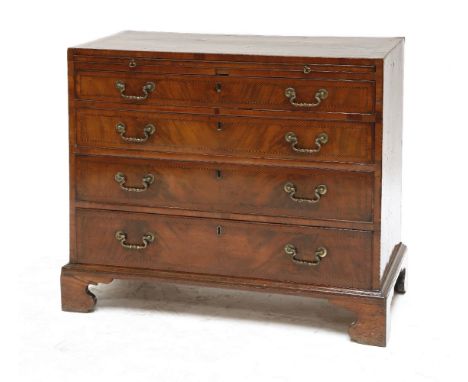 A George III chequer strung mahogany chest of drawers,having a brushing slide over four long graduated drawers with original 