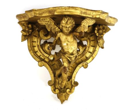 A carved giltwood wall bracket, 39cm high, anda pair of modern gilt wall brackets,32cm high (3)