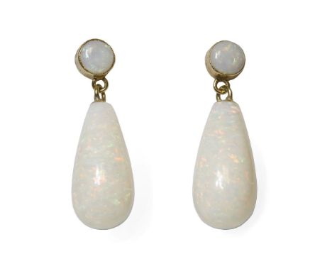 A pair of gold opal drop earrings, with a circular opal cabochon rub set to the top, with a carved opal pippin below (2)