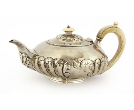 A  George IV silver teapot,by Henry Day, London 1821, of compressed circular form with broad flutes and a scroll cartouche, i