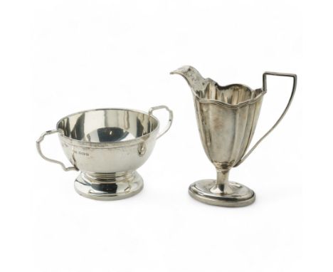 Victorian silver helmet shape cream jug of panel sided design with reeded handle and oval foot London 1899 Maker Thomas Bradb