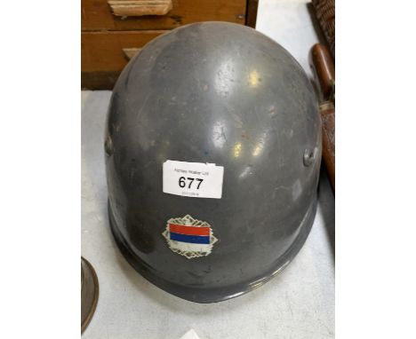 A VINTAGE METAL ARMY HELMET WITH SERBIAN FLAG 