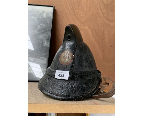 A VINTAGE LEATHER FIREMANS HELMET WITH NFS PRINTED BADGE 