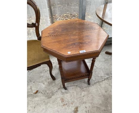 A SMALL OCTAGONAL OCCASIONAL TABLE ON CASTERS WITH LOWER GALLERIED SHELF 