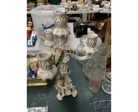 A CONTINENTAL HARD PASTE PORCELAIN FIGURAL CANDLESTICK 