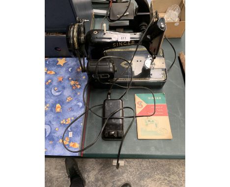 A VINTAGE SINGER SEWING MACHINE WITH LEAFLET AND PEDAL 