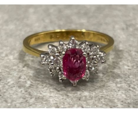 Ladies 18ct gold Ruby and Diamond cluster ring. Featuring oval shaped ruby surrounded by 14 round brilliant cut diamonds. Siz
