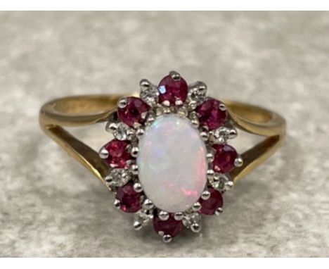 9ct gold oval Opal, diamond and Ruby ring. Comprising of 8 diamonds and 8 Rubies. 2.3G size N1/2